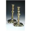 Image 1 : A pair of late 18th century brass candlesticks, the vase nozzles with flared rims above baluster an.