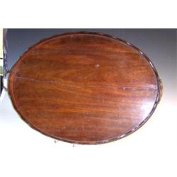 A 19th century mahogany tray, brass handles at each end of the wavy gallery above the oval tray, 67.