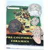 Image 1 : Four Pre-Columbian artefacts and a book, each of the heads modelled from clay, a black and a grey p.