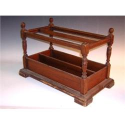 A late 19th century mahogany stained pine music Canterbury, the two compartments with baluster turn.