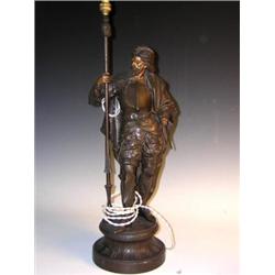 An early 20th century French spelter lamp, modelled as a Renaissance knight standing wearing armour.