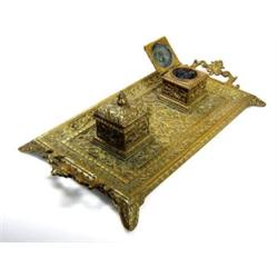 A mid Victorian brass inkstand, the two handled rectangular tray cast with Arabesques and supportin.