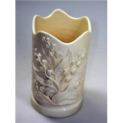 A 19th century ivory spill vase, possibly German, the cylindrical sides carved in relief on one sid.