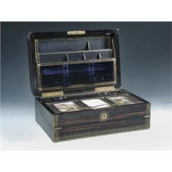 A mid 19th century French coromandel wood writing slope, the rectangular lid rounded at the front a.