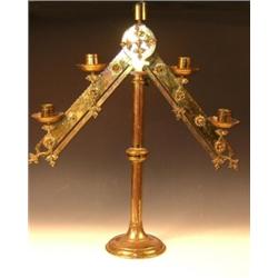 A Victorian Neogothic brass candelabra, the five lights arranged on a wavy edged inverted chevron b.