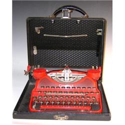 A black leatherette cased red Corona portable typewriter, the qwerty keyboard above the label 'LC S.