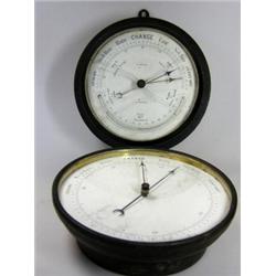 'J Bruce, Liverpool', an aneroid barometer and arc thermometer in circular painted metal case, bear.