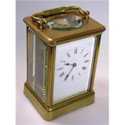 A late 19th century French carriage timepiece the enamel dial in glazed brass obis case, 14.5cm hig.