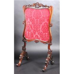 A William IV rosewood framed fire screen, the silk work panel within an acanthus and scroll carved..