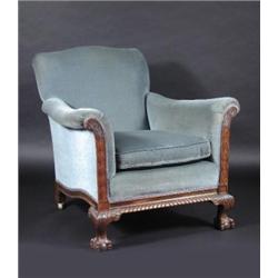 A 19th century mahogany library chair, the arched padded back above padded arms and cushion seat wi.