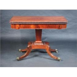A Regency mahogany pedestal tea table, the rounded rectangular fold over top with gadrooned edge ab.