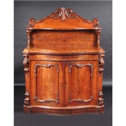 A William IV mahogany serpentine chiffonier, the scroll carved back incorporating a shaped shelf on.