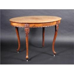 A continental mahogany centre table, the oval top above a wavy frieze supported on cartouche and ac.