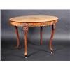 Image 1 : A continental mahogany centre table, the oval top above a wavy frieze supported on cartouche and ac.