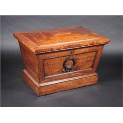 A 19th century mahogany cellaret, the rectangular rising top above tapering panelled sides applied..