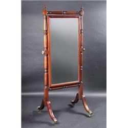 A William IV mahogany framed cheval glass, the rectangular plate supported on finial mounted turned.