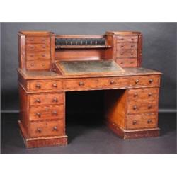 A Victorian mahogany Dickens desk, the spindle turned back above a single shelf flanked with short..