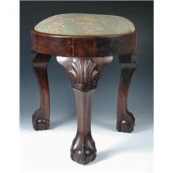 A 19th century mahogany stool, the circular drop in seat above a plain frieze, standing on shell ca.