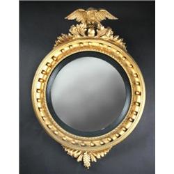 A Regency gilt framed convex wall glass, the circular plate within an ebonised slip and abacus fram.