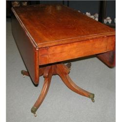 A 19th century mahogany Pembroke table, the moulded rounded rectangular twin flap top above an end..