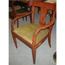 A set of eight Biedermier style mahogany dining chairs including two with arms, each with broad bow.