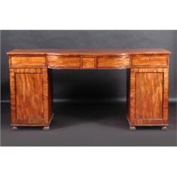 A Regency mahogany bowfront pedestal sideboard, the shaped top above three panelled frieze drawers..