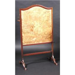 A 19th century mahogany framed fire screen, the adjustable screen incorporating a shelf, standing o.