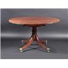 Image 1 : A Regency mahogany breakfast table, the circular tilt top supported on a ring turned column, standi.