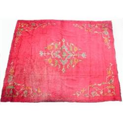 An Ushak wool carpet, the wine red field enclosing a central foliate medallion within similar spand.