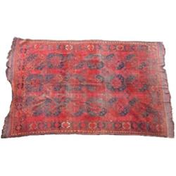 An Afghan wool Esari, the wine red field enclosing three rows of six guls interspersed with crucifo.