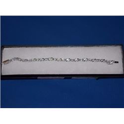 BRACELET - 12 OVAL FACETED BLUE TOPAZ & DIAMOND IN STERLING SILVER CROSS OVER LINK DESIGNED SETTING 