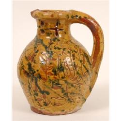 An Early 19th Century Donyatt Pottery Puzzle Jug, decorated tulips and birds, initialled MT and date