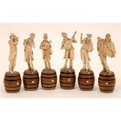 A Six Piece European Carved Ivory Vagabond Band, standing on a turned wooden barrel, 15 cm (a.f.) S