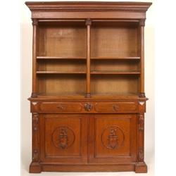 A William IV Oak Library Bookcase, the moulded cornice above adjustable shelves, two frieze drawers