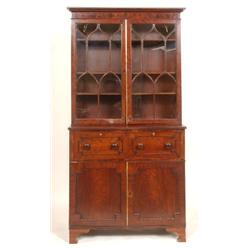 A Mahogany Bookcase on Cupboard, with a pair of glazed doors above a frieze drawer, with cupboard be