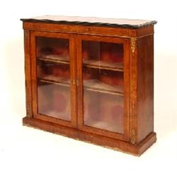 A Victorian Walnut Side Cabinet, with inlaid freize above a pair of glazed doors, with gilt metal mo