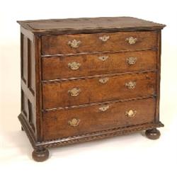 A Oak Chest, with panelled sides, four graduated long drawers, and bun feet, 98 cm See illustration