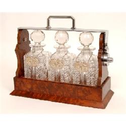 An Amboyna Three Bottle Tantalus, with plated mounts, 32 cm See illustration