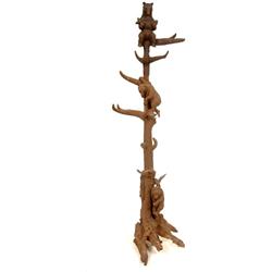 A Black Forest Style Hat Stand, carved a bear and fish, with two climbing bears beneath, on a root f