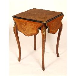 A French Marquetry Inlaid Rosewood Occasional Table, with serpentine drop flaps, and gilt metal moun
