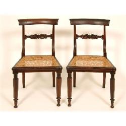 A Set of Six Late Regency Rosewood Dining Chairs, with carved back rails, and caned seats on hexagon
