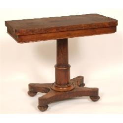 A Victorian Rosewood Card Table, the rectangular fold over top on a turned column with quatrefoil ba