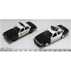 FLAT OF TWO 1:24 SCALE DIE CAST POLICE CARS