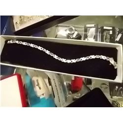 BRACELET - 6CTW (12) LIVELY BLUE TOPAZS & DIAMOND IN STERLING SILVER CROSS OVER LINK DESIGN SETTING 