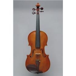 A GERMAN VIOLIN, bearing a label reading Alfredo Guastalla, the one piece back of narrow horizont...