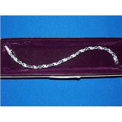 BRACELET - 6CTW (12) LIVELY BLUE TOPAZS & DIAMOND IN STERLING SILVER CROSS OVER LINK DESIGN SETTING 