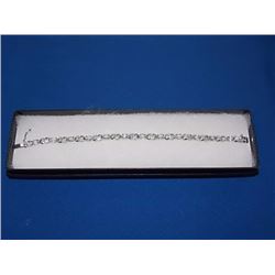 BRACELET - 6CTW (12) LIVELY BLUE TOPAZS & DIAMOND IN STERLING SILVER CROSS OVER LINK DESIGN SETTING 