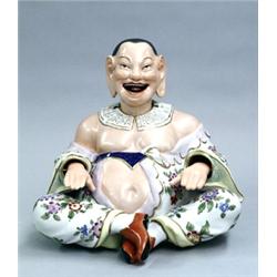 DRESDEN PORCELAIN PAGODA FIGURE, German. 20th Century. The corpulent smiling male seated cross-...