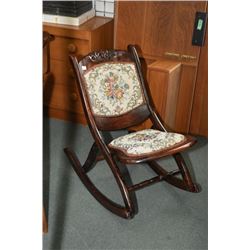 Vintage folding nursing rocker with carved floral decoration and tapestry upholstered seat and back