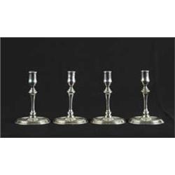FOUR EARLY SILVER PLATED CANDLESTICKS